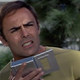 John Saxon as Dylan Hunt, reporting from the 22nd century in Planet Earth.